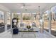 Bright sunroom features a patterned ceiling, large windows, and a sofa at 10016 Porto Fino Ave, Wake Forest, NC 27587