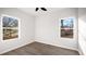 Bright bedroom featuring two windows, new flooring, and fresh paint at 1012 W Webb Ave, Burlington, NC 27217
