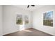 Bright bedroom with three large windows and wood-look vinyl floors at 1012 W Webb Ave, Burlington, NC 27217
