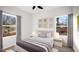 Bright bedroom with large windows, neutral decor, and ceiling fan at 1012 W Webb Ave, Burlington, NC 27217