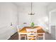 Bright dining room with wood table, stylish chandelier, and white walls at 1012 W Webb Ave, Burlington, NC 27217