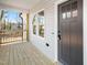 Inviting covered front porch with gray siding and a dark-colored front door at 1012 W Webb Ave, Burlington, NC 27217