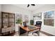 Home office with a large wood desk and natural light from two windows at 1012 W Webb Ave, Burlington, NC 27217