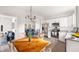 Open-concept kitchen and dining area with stainless steel appliances and modern lighting at 1012 W Webb Ave, Burlington, NC 27217