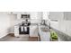 Modern kitchen with stainless steel appliances, granite countertops, and white cabinets at 1012 W Webb Ave, Burlington, NC 27217