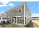 Back exterior of home showing the neutral siding, windows, and the backyard patio at 1029 Benay Rd, Morrisville, NC 27560