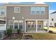 Back exterior view featuring neutral siding, a covered patio, and a compact yard at 1029 Benay Rd, Morrisville, NC 27560