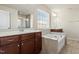 Bright bathroom featuring double sink vanity, soaking tub, and tile accents at 1029 Benay Rd, Morrisville, NC 27560