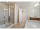 Bathroom with a glass-enclosed shower, tile flooring, and view into the spacious main bedroom at 1029 Benay Rd, Morrisville, NC 27560