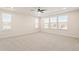 Bright, carpeted bedroom with multiple windows and a ceiling fan for natural light and comfort at 1029 Benay Rd, Morrisville, NC 27560
