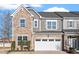 Charming townhome with a stone facade, two-car garage, and beautifully manicured front yard at 1029 Benay Rd, Morrisville, NC 27560