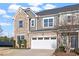 Stylish townhome showcasing a stone and siding exterior with an attached two-car garage at 1029 Benay Rd, Morrisville, NC 27560
