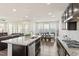 Open kitchen with large island, connecting to the dining and living areas at 1029 Benay Rd, Morrisville, NC 27560