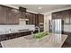 Modern kitchen featuring dark cabinets, stainless steel appliances, and granite countertops at 1029 Benay Rd, Morrisville, NC 27560