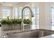 Close up of a kitchen island sink with a view of the backyard and interior at 1029 Benay Rd, Morrisville, NC 27560