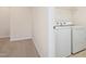 Laundry room with washer, dryer, and wire shelving at 1029 Benay Rd, Morrisville, NC 27560