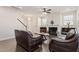 Inviting living room featuring a fireplace, hardwood floors, and plush leather sofas at 1029 Benay Rd, Morrisville, NC 27560
