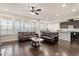 Open-concept living area featuring hardwood floors, comfortable sofas, and a modern kitchen at 1029 Benay Rd, Morrisville, NC 27560