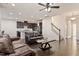 Open-concept living area with hardwood floors, leather sofas, and kitchen view at 1029 Benay Rd, Morrisville, NC 27560