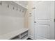 Welcoming mudroom with white cabinets, hooks and bench with shoe storage at 1029 Benay Rd, Morrisville, NC 27560