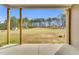 A covered porch looks out on a large back yard at 1076 Nc 55, Coats, NC 27521