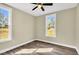 A bedroom has two windows and a ceiling fan at 1076 Nc 55, Coats, NC 27521