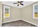 This bedroom has two windows and a ceiling fan at 1076 Nc 55, Coats, NC 27521