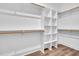 A walk-in closet features white shelving and wood-look flooring at 1076 Nc 55, Coats, NC 27521