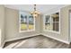 Bright dining room with large windows and modern lighting fixture, filled with natural light at 1076 Nc 55, Coats, NC 27521