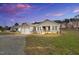 Charming single-story home featuring a two-car garage and beautiful landscaping at 1076 Nc 55, Coats, NC 27521