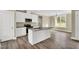 Open kitchen featuring a central island, stainless steel appliances, and ample cabinet space at 1076 Nc 55, Coats, NC 27521