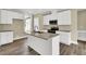 Modern kitchen showcasing an island with a sink, granite countertops, and white cabinetry at 1076 Nc 55, Coats, NC 27521