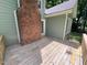 Back deck with stairs and brick chimney on exterior at 1116 Shadywood Ln, Raleigh, NC 27603