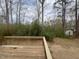 Back deck with wood planks overlooking a mature wooded area and a glimpse of the home at 1116 Shadywood Ln, Raleigh, NC 27603