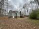 Backyard view of the home showcasing its lovely green exterior and spacious backyard at 1116 Shadywood Ln, Raleigh, NC 27603