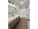 Clean bathroom featuring a white vanity, white tile shower, and modern finishes at 1116 Shadywood Ln, Raleigh, NC 27603