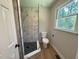 Bathroom featuring new tile shower, black fixtures, and neutral paint at 1116 Shadywood Ln, Raleigh, NC 27603