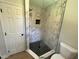 New bathroom featuring updated tile shower and black fixtures at 1116 Shadywood Ln, Raleigh, NC 27603
