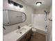 This bathroom features a modern vanity, an oval mirror, updated fixtures, and a shower-tub combo at 1116 Shadywood Ln, Raleigh, NC 27603