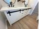This bathroom features a modern vanity, white cabinets, modern pulls, and hardwood floors at 1116 Shadywood Ln, Raleigh, NC 27603