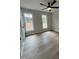This bedroom features neutral walls, hardwood floors, two windows, and a modern ceiling fan at 1116 Shadywood Ln, Raleigh, NC 27603