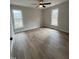 This bedroom features neutral walls, hardwood floors, two windows, and ample space at 1116 Shadywood Ln, Raleigh, NC 27603