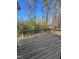 A spacious wooden deck overlooks a lush, wooded backyard, offering serene outdoor living at 1116 Shadywood Ln, Raleigh, NC 27603