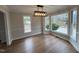 Bright dining area with hardwood floors, large windows, decorative trim, and modern light fixture at 1116 Shadywood Ln, Raleigh, NC 27603
