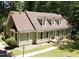Charming single-story home with light green siding, a new roof, and dormer windows at 1116 Shadywood Ln, Raleigh, NC 27603
