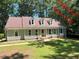Charming light green single-story home featuring a new brown roof and manicured lawn with mature trees at 1116 Shadywood Ln, Raleigh, NC 27603