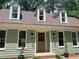 Charming home featuring a lovely front porch with three dormer windows and a well-manicured lawn at 1116 Shadywood Ln, Raleigh, NC 27603
