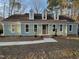 Charming home with light green siding, dormer windows, and manicured front yard at 1116 Shadywood Ln, Raleigh, NC 27603