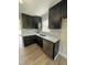 Modern kitchen features sleek black cabinets, quartz countertops, stainless steel appliances, and stylish backsplash at 1116 Shadywood Ln, Raleigh, NC 27603