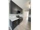 Elegant kitchen showcases black cabinets, stainless steel microwave and range, and light wood flooring at 1116 Shadywood Ln, Raleigh, NC 27603